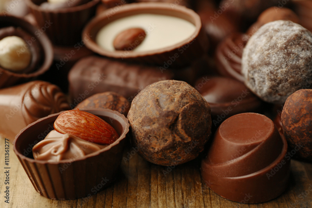 Assortment of delicious chocolate candies background, close up