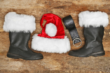 Wall Mural - Santa Claus costume on wooden background, close up