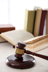 Wall Mural - Gavel with books on wooden table closeup