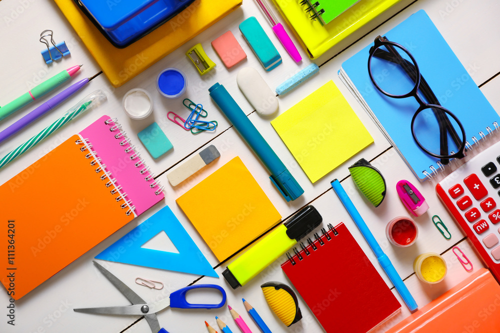 Flat lay of stationery on white wooden table background