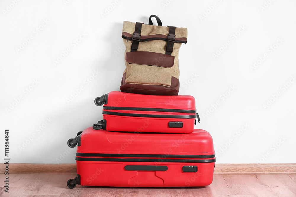 Suitcases on white wall background