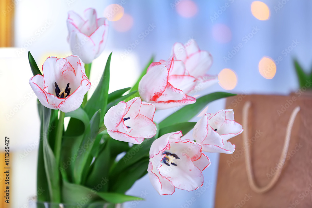 Bouquet of fresh tulips beside the mirror