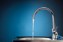 Mixer Tap With Flowing Water, Blue Background