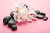 Fototapeta Storczyk - Spa stones and white orchid on pink background