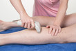 Laser hair removal on man legs at beauty center