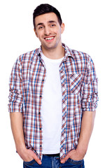 Handsome in style. Cheerful young man in smart casual wear looking at camera and holding hands in pockets while standing against white isolated background