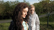 © kirill4mula - Two smiley merry and cheerful young women or girls friends walking in the green park outdoors in spring against the sunset. Togetherness and friendship positive concept.