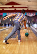 © Syda Productions - happy young man throwing ball in bowling club