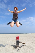 Joy/ Woman Jumping Of A Pole On The Beach For Sheer Joy