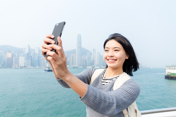 Wall Mural - Woman taking self image by cellphone