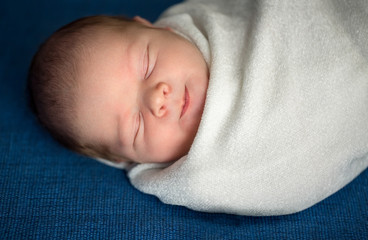 Adorable little baby sleeping and smiling