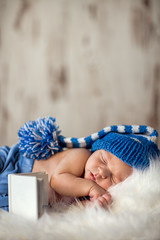 Wall Mural - newborn baby sleeps on a white blanket