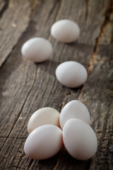 Wall Mural - White chicken eggs, on wooden surface