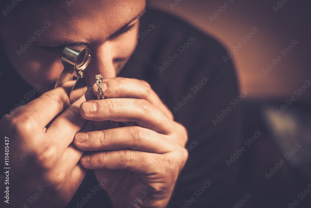 Portrait of a jeweler during the evaluation of jewels. - obrazy, fototapety, plakaty 