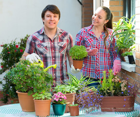 Smiling couple working with flowers.