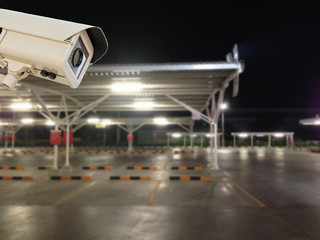 Wall Mural - CCTV Security Camera operating in parking lot car.