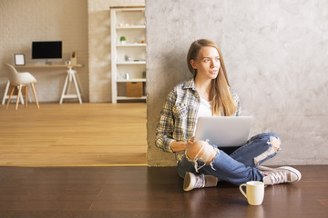 Female using laptop in interior