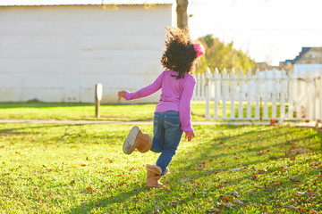 Wall Mural - kid girl toddler playing running in park rear view