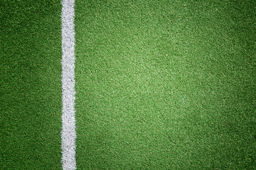 Soccer grass playground detail with white goal line copy space background.