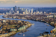 London, England - Aerial Skyline View Of East London With River Thames And The Skyscrapers Of Canary Wharf At Background