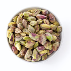 Wall Mural - Dish of Shelled Pistachio Kernels Isolated on White Overhead Vie