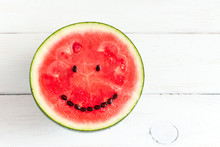 Watermelon With Smile On White Wooden Background