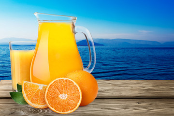 Canvas Print - Pitcher with highball of orange juice with oranges