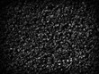 © MADDRAT - Black sand grunge background. Сlose-up.