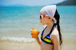 © Alinute - Kid girl with juice on the beach