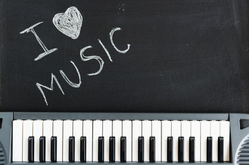 Music keyboard on blackboard background - I love music