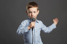 Little Boy With Microphone. Funny Child Singing In Karaoke. Artist Sing A Song