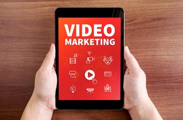 Two hand holding tablet with Video marketing and icon on screen