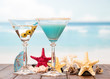 Cocktails, starfish and sinks on sea background.