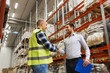 © Syda Productions - worker and businessmen with clipboard at warehouse