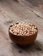 Wall Mural - dry chickpeas in a wooden bowl