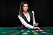 © nazarovsergey - The beautiful girl, dealer, behind a table for poker