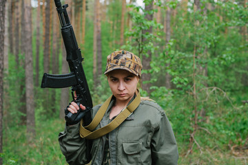 Wall Mural - A woman soldier with a weapon