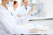 © rogerphoto - Scientific research team with clear solution in laboratory