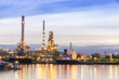 © Pawinee - Oil refinery plant at twilight with copy space.