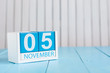 November 5th. Image of november 5 wooden color calendar on blue background. Autumn day. Empty space for text
