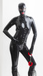 © Richard Semik - standing woman wearing latex clothes with handcuffs