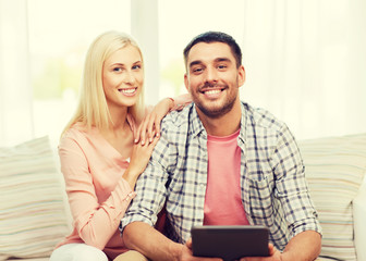 Poster - smiling happy couple with tablet pc at home