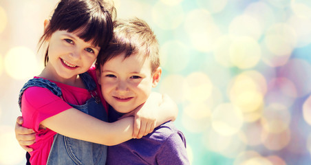 Poster - two happy kids hugging over blue lights background