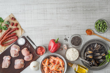 Ingredients for paella on the white  table top view