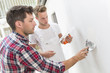 © Atelier 211 - Young apprentice with professional plasterer