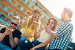 © ivanko80 - Smiling group of people eating pizza outdoors