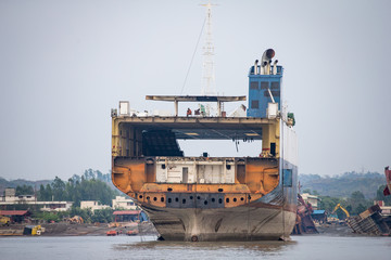 partially broken down ocean ship at a shipbreaking yard in chittagong, bangladesh