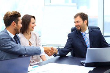 Business colleagues sitting at a table during a meeting with two