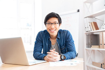 Poster - Cheerful businessman working with laptop on workplace