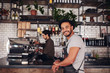 © Jacob Lund - Happy young male coffee shop owner standing